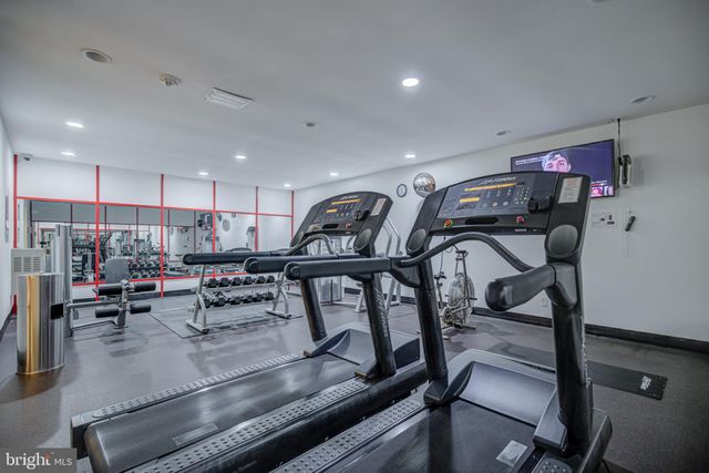 a room with gym equipment and a flat screen tv