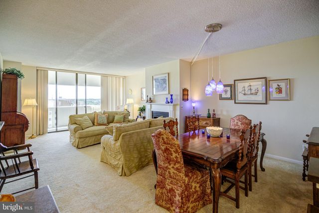 a living room with furniture a flat screen tv and a window