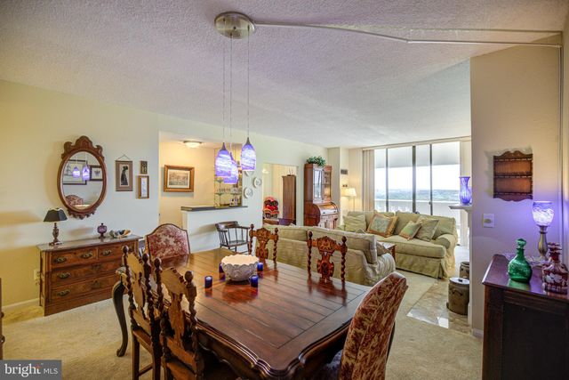 a dining room with furniture and a window