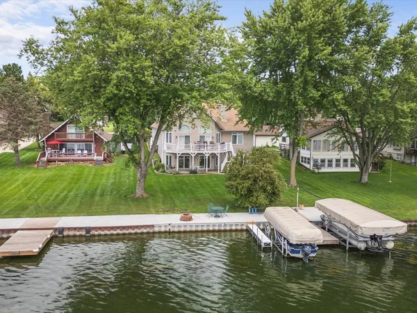 a living room with fireplace furniture and a chandelier