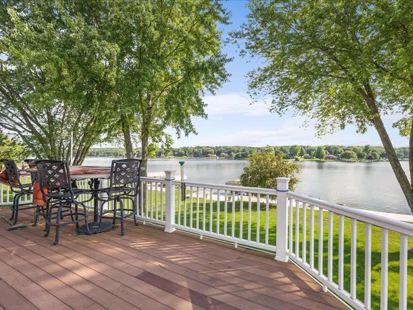 a view of a swimming pool with a patio and a yard
