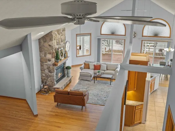 a living room with furniture and a floor to ceiling window