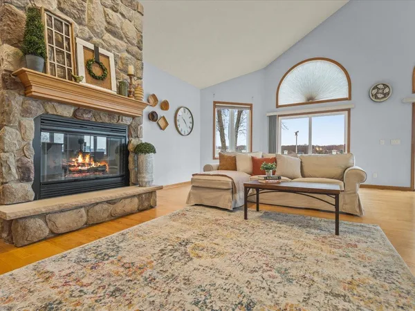 a living room with furniture and floor to ceiling windows