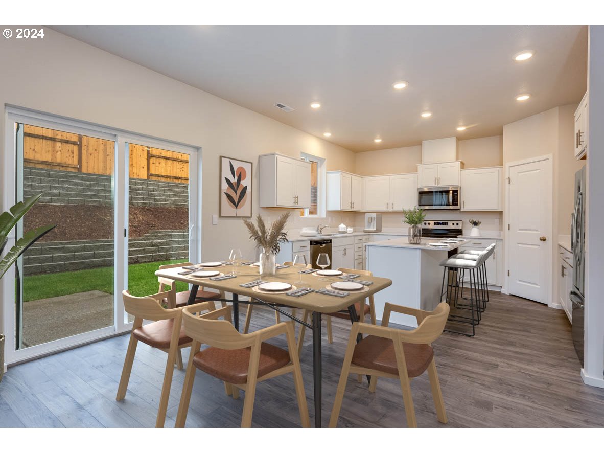 3362 Southeast 36th Street Gresham, OR 97080 - Photo 18 of 21 a view of a dining room with furniture and wooden floor
