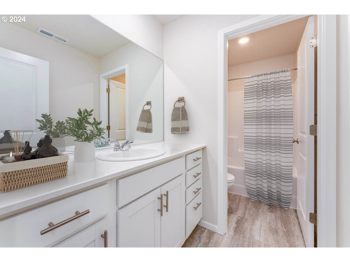 3362 Southeast 36th Street Gresham, OR 97080 - Photo 8 of 21 a bathroom with a sink a potted plant and a mirror
