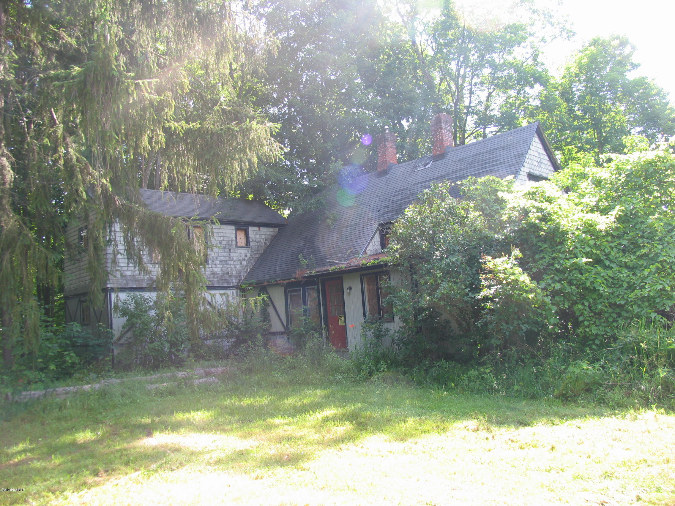 53 Interlaken Road Stockbridge, MA 01266 - Photo 5 of 5 a backyard of a house with yard table and chairs
