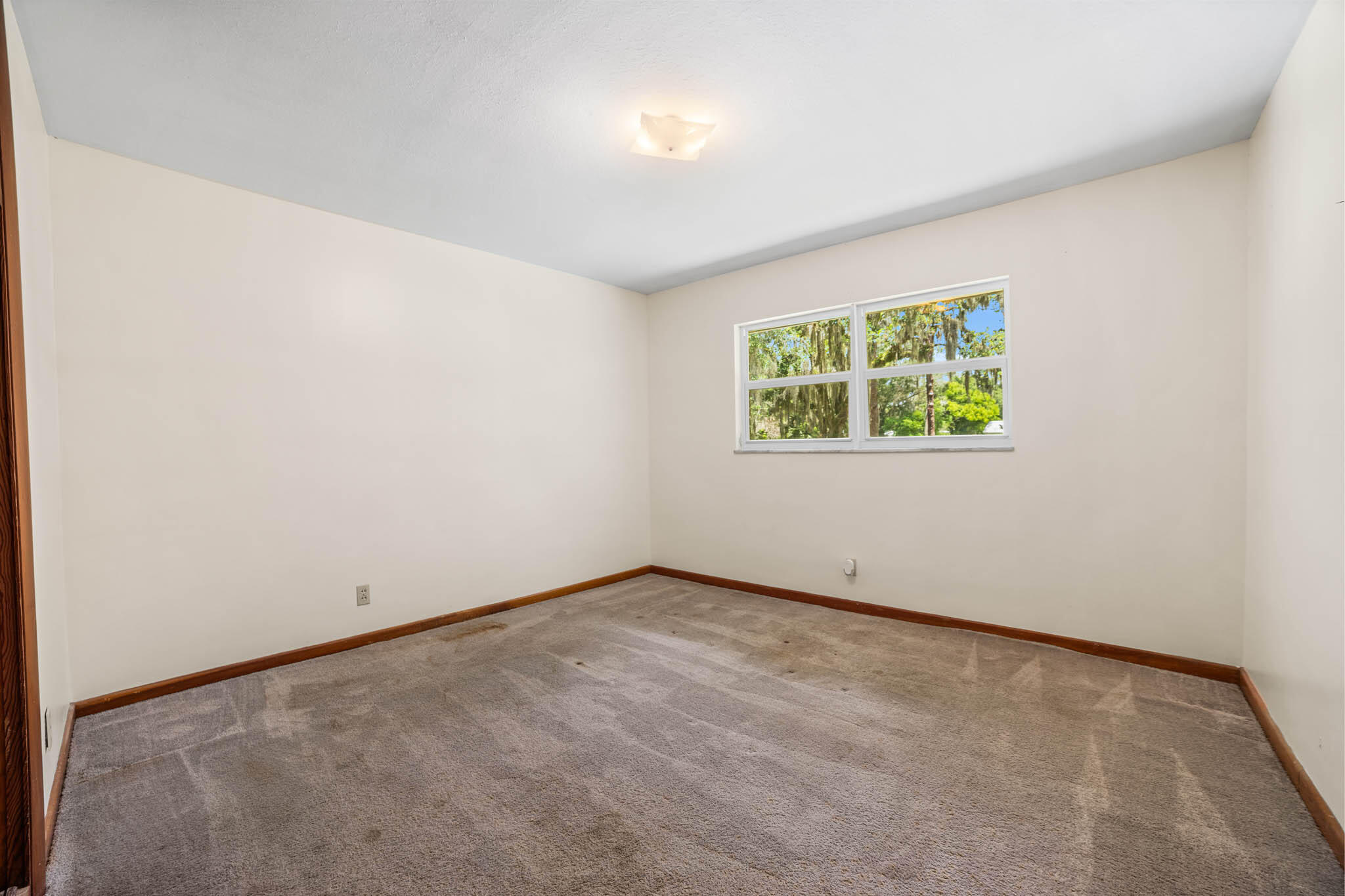 409 Southwest 15th Street Okeechobee, FL 34974 - Photo 11 of 14 an empty room with windows