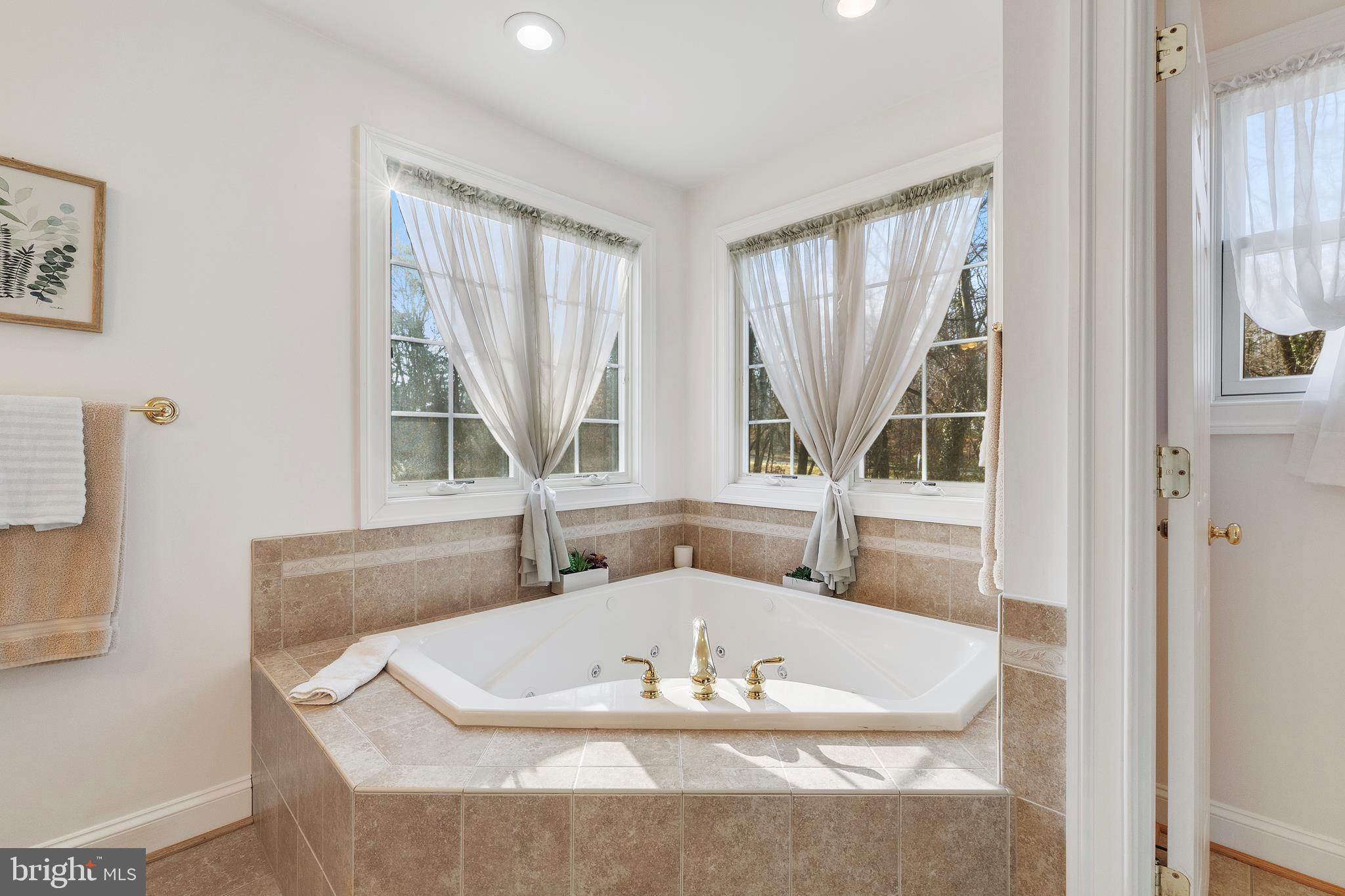 518 North Old Hammonds Ferry Road Linthicum Heights, MD 21090 - Photo 34 of 57 a bath tub sitting in a bathroom next to a window