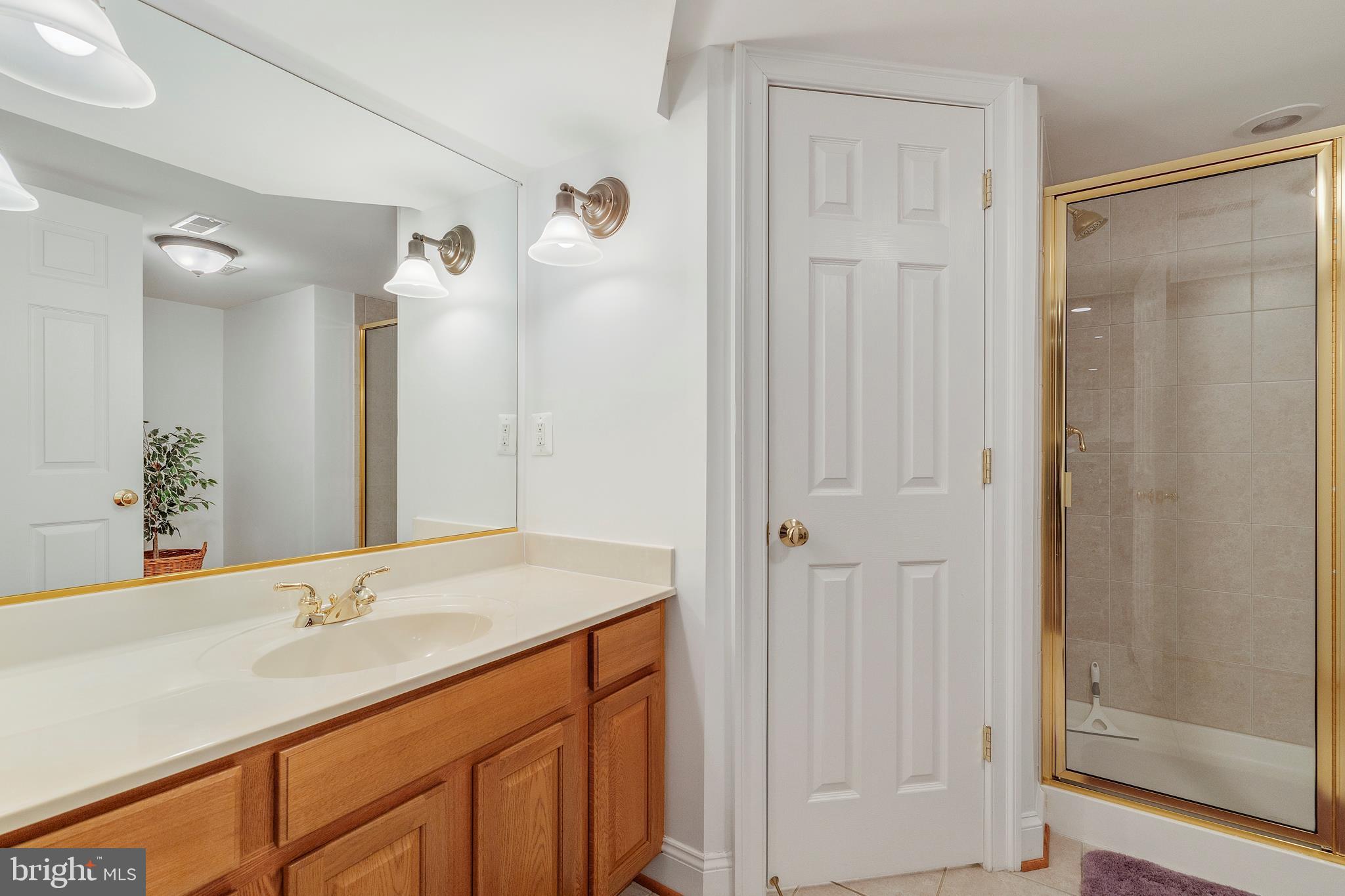 518 North Old Hammonds Ferry Road Linthicum Heights, MD 21090 - Photo 40 of 57 a bathroom with a shower sink and mirror