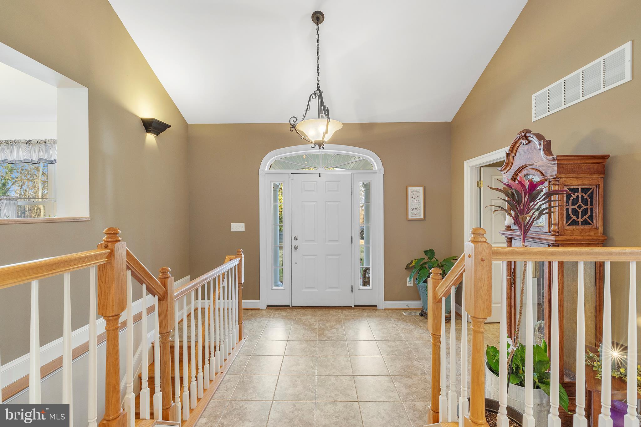 518 North Old Hammonds Ferry Road Linthicum Heights, MD 21090 - Photo 5 of 57 a view of a hallway to a livingroom with wooden floor and stairs