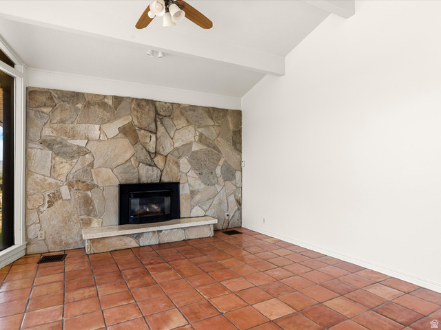 15680 North Beaver Dam Road Collinston, UT 84306 - Photo 8 of 49 Living area featuring a stone accent wall with an integrated fireplace and a light-colored hearth