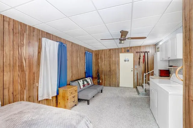 a bedroom with furniture and a chandelier