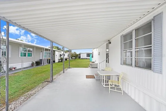 a view of an house with backyard porch and garden