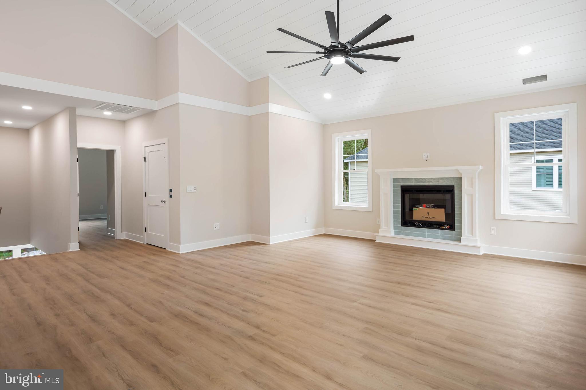 38697 Fred Hudson Road Bethany Beach, DE 19930 - Photo 33 of 51 a view of an empty room with wooden floor fireplace and a window