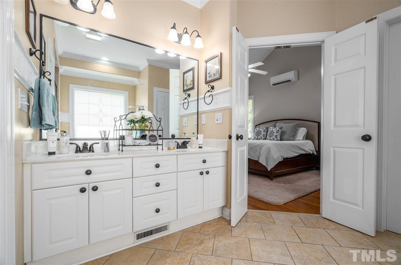 9408 Gabe Court Raleigh, NC 27613 - Photo 15 of 30 a en suite bathroom with a double sink and mirror
