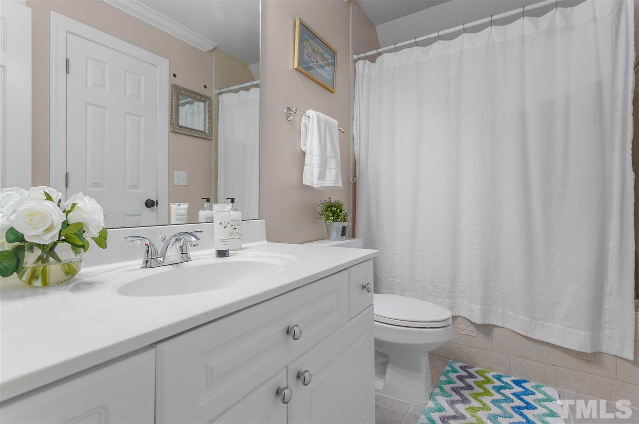 9408 Gabe Court Raleigh, NC 27613 - Photo 24 of 30 a bathroom with a sink a toilet and a mirror