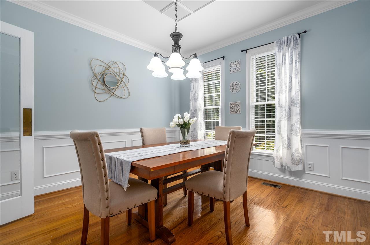 9408 Gabe Court Raleigh, NC 27613 - Photo 6 of 30 a dining room with furniture a chandelier and wooden floor