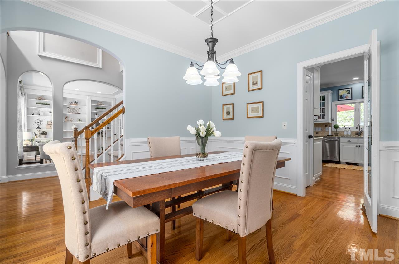 9408 Gabe Court Raleigh, NC 27613 - Photo 7 of 30 a view of a dining room with furniture wooden floor and chandelier