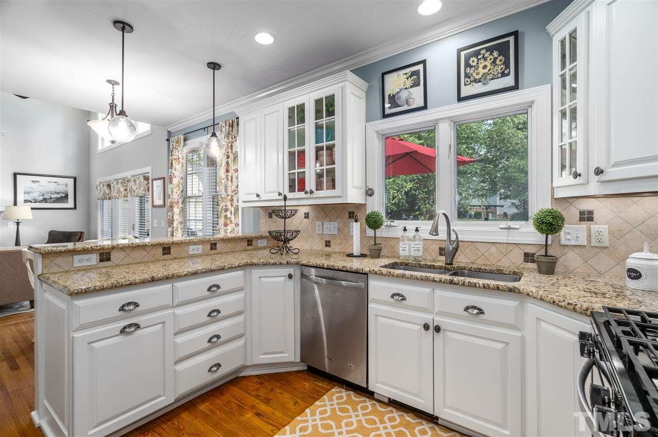 9408 Gabe Court Raleigh, NC 27613 - Photo 8 of 30 a kitchen with stainless steel appliances granite countertop a lot of counter space and a window