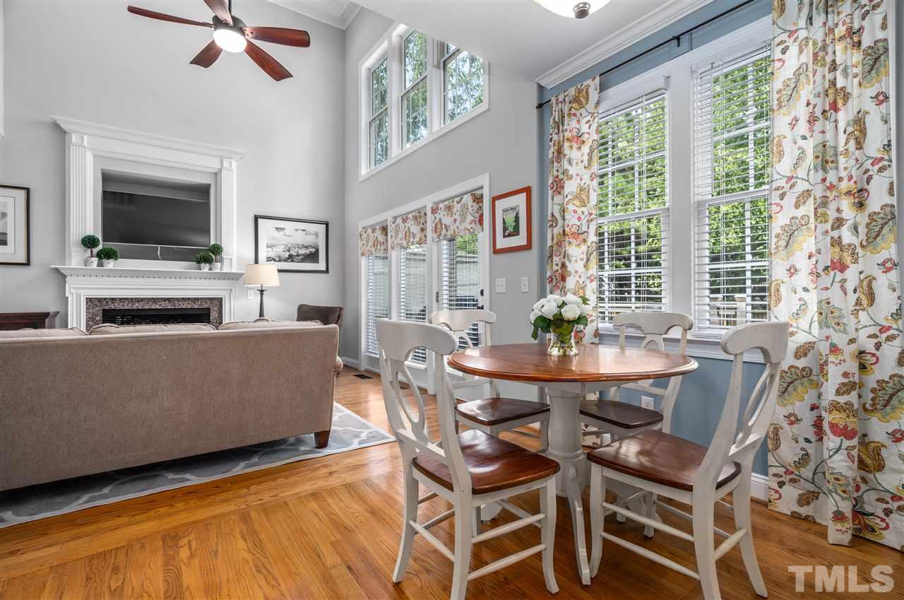 9408 Gabe Court Raleigh, NC 27613 - Photo 10 of 30 a living room with furniture a flat screen tv and a large window