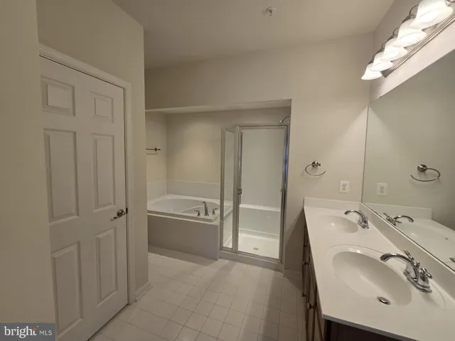 a spacious bathroom with a sink a mirror and a bathtub