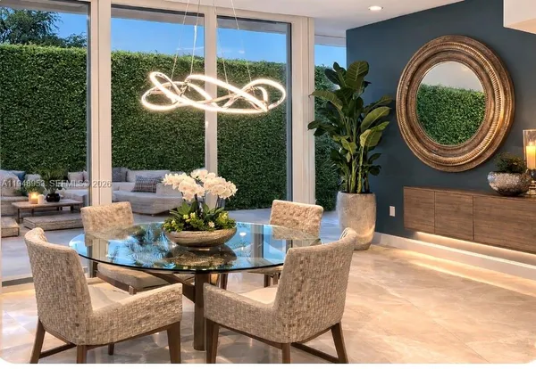 a dining room with furniture and a large window