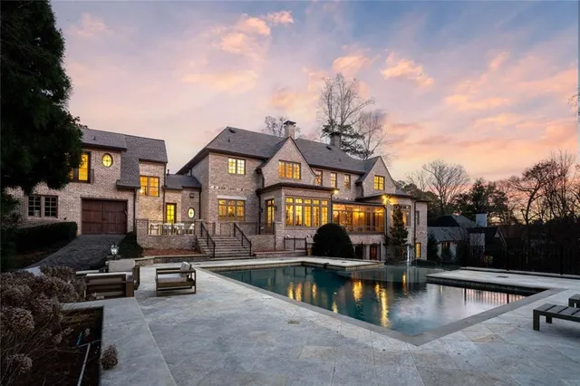 a view of a building with swimming pool and sitting area