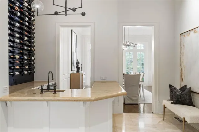 a living room with furniture a chandelier and a fireplace