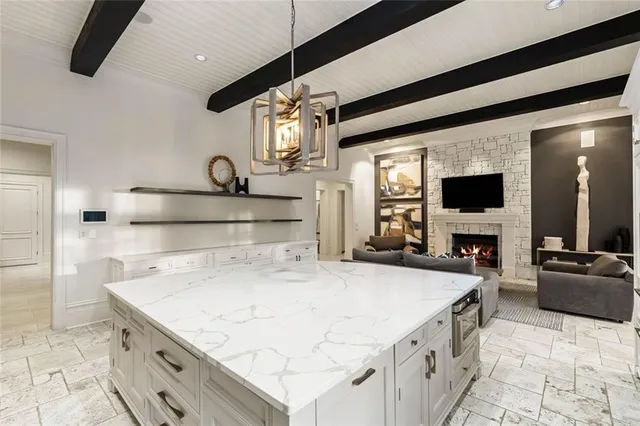 a spacious bedroom with a bed and a flat screen television