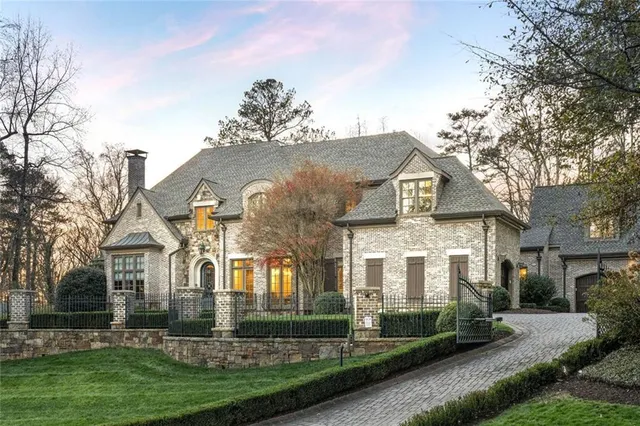 a front view of house with a garden