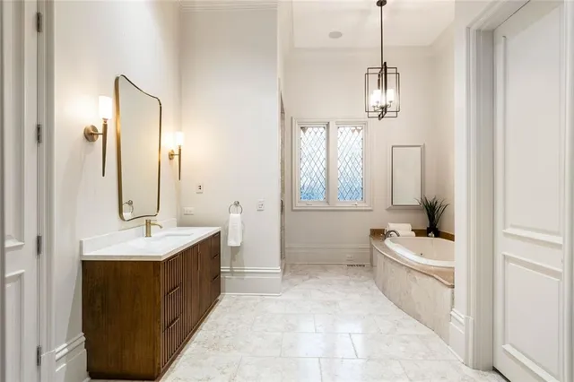 a spacious bedroom with a bed and a chandelier