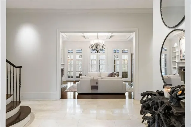 a living room with furniture a fireplace and a floor to ceiling window