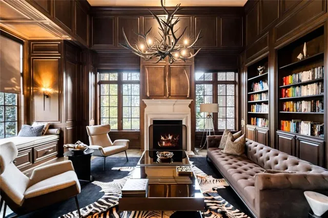 a living room with fireplace furniture and a chandelier