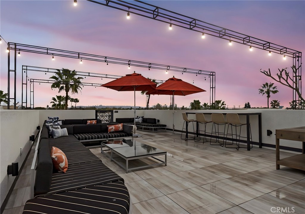 431 South Anaheim Way, Unit 5 Orange, CA 92868 - Photo 35 of 35 a terrace with outdoor seating and wooden floor