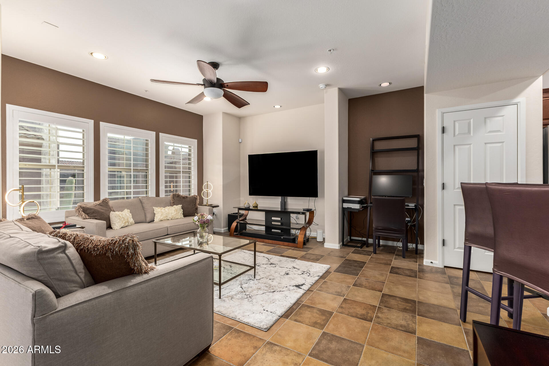 3935 East Rough Rider Road, Unit 1197 Phoenix, AZ 85050 - Photo 11 of 51 a living room with furniture a large window and a flat screen tv