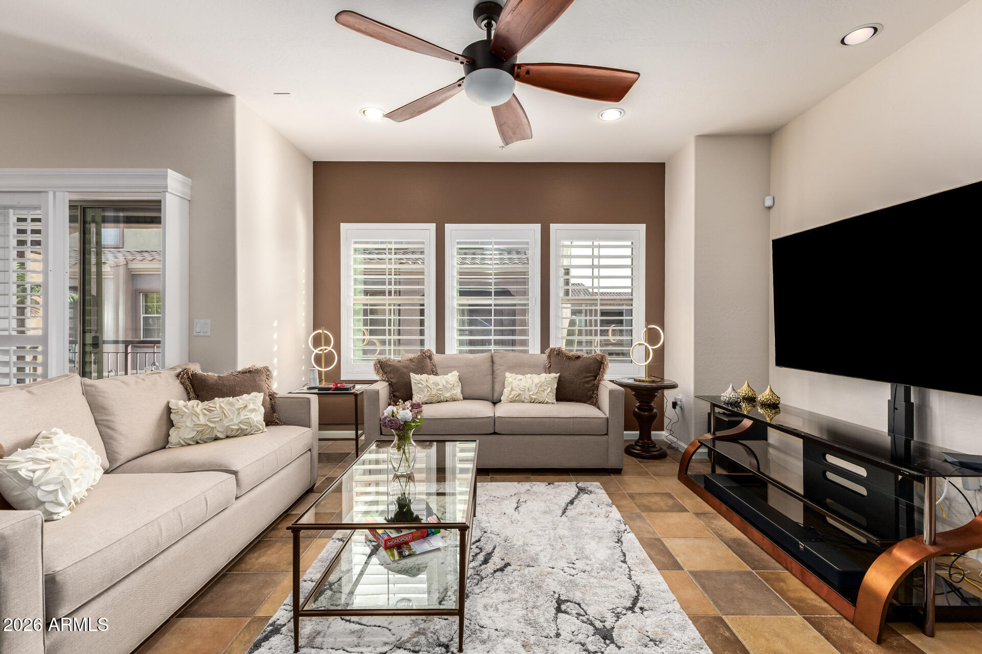 3935 East Rough Rider Road, Unit 1197 Phoenix, AZ 85050 - Photo 12 of 51 a living room with furniture and a flat screen tv