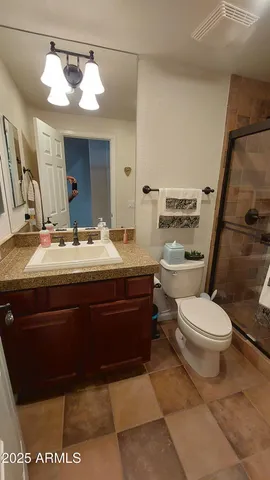 a kitchen with a refrigerator and a stove top oven