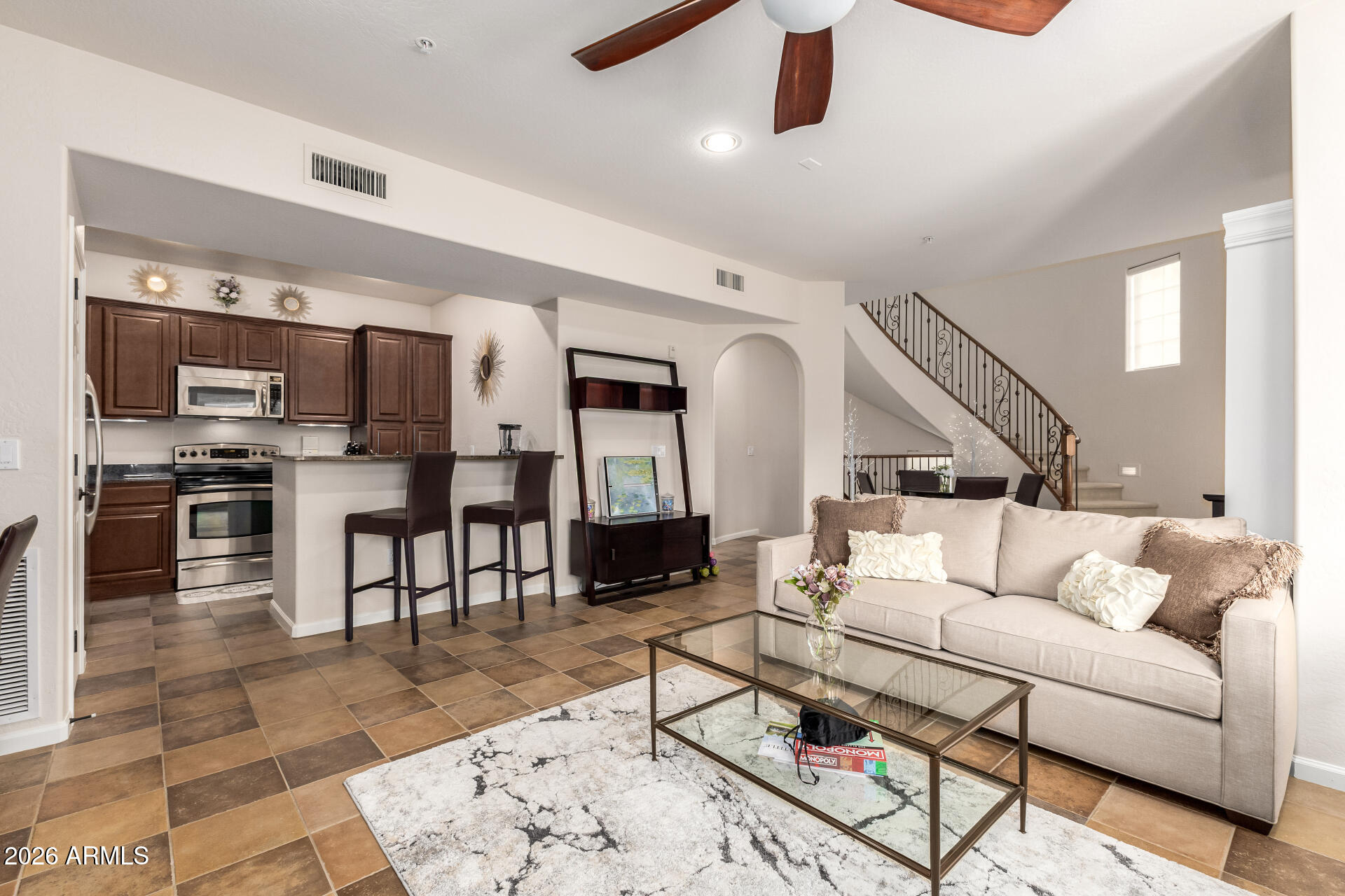 3935 East Rough Rider Road, Unit 1197 Phoenix, AZ 85050 - Photo 19 of 51 a living room with furniture kitchen view and a wooden floor