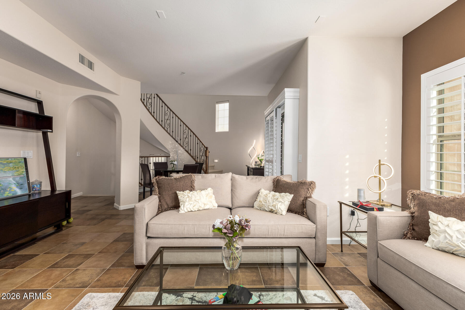 3935 East Rough Rider Road, Unit 1197 Phoenix, AZ 85050 - Photo 20 of 51 a living room with furniture and a flat screen tv