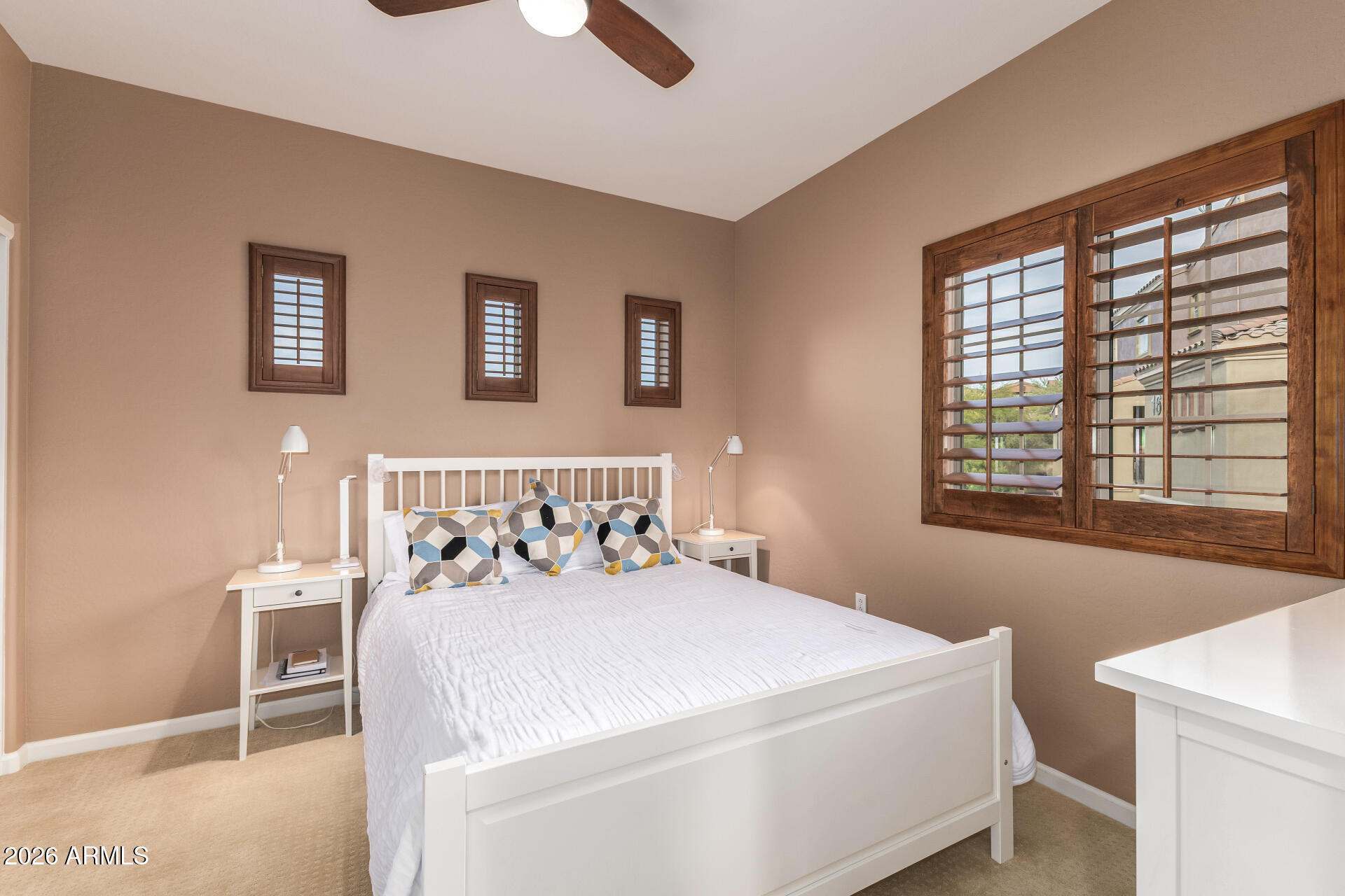 3935 East Rough Rider Road, Unit 1197 Phoenix, AZ 85050 - Photo 22 of 51 a bedroom with a bed and a window