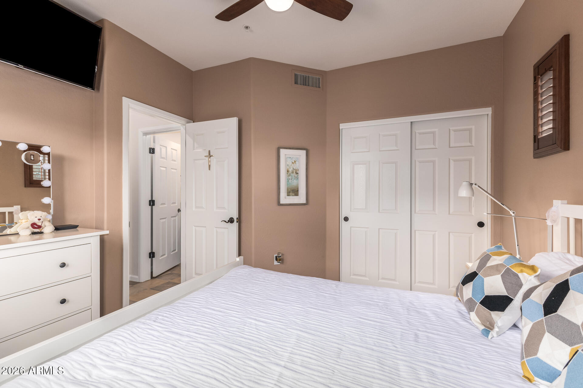 3935 East Rough Rider Road, Unit 1197 Phoenix, AZ 85050 - Photo 23 of 51 a bedroom with a bed and a chandelier