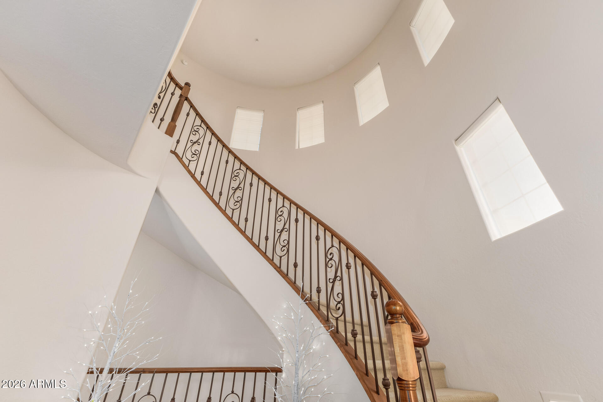 3935 East Rough Rider Road, Unit 1197 Phoenix, AZ 85050 - Photo 25 of 51 a view of staircase with railing and white walls