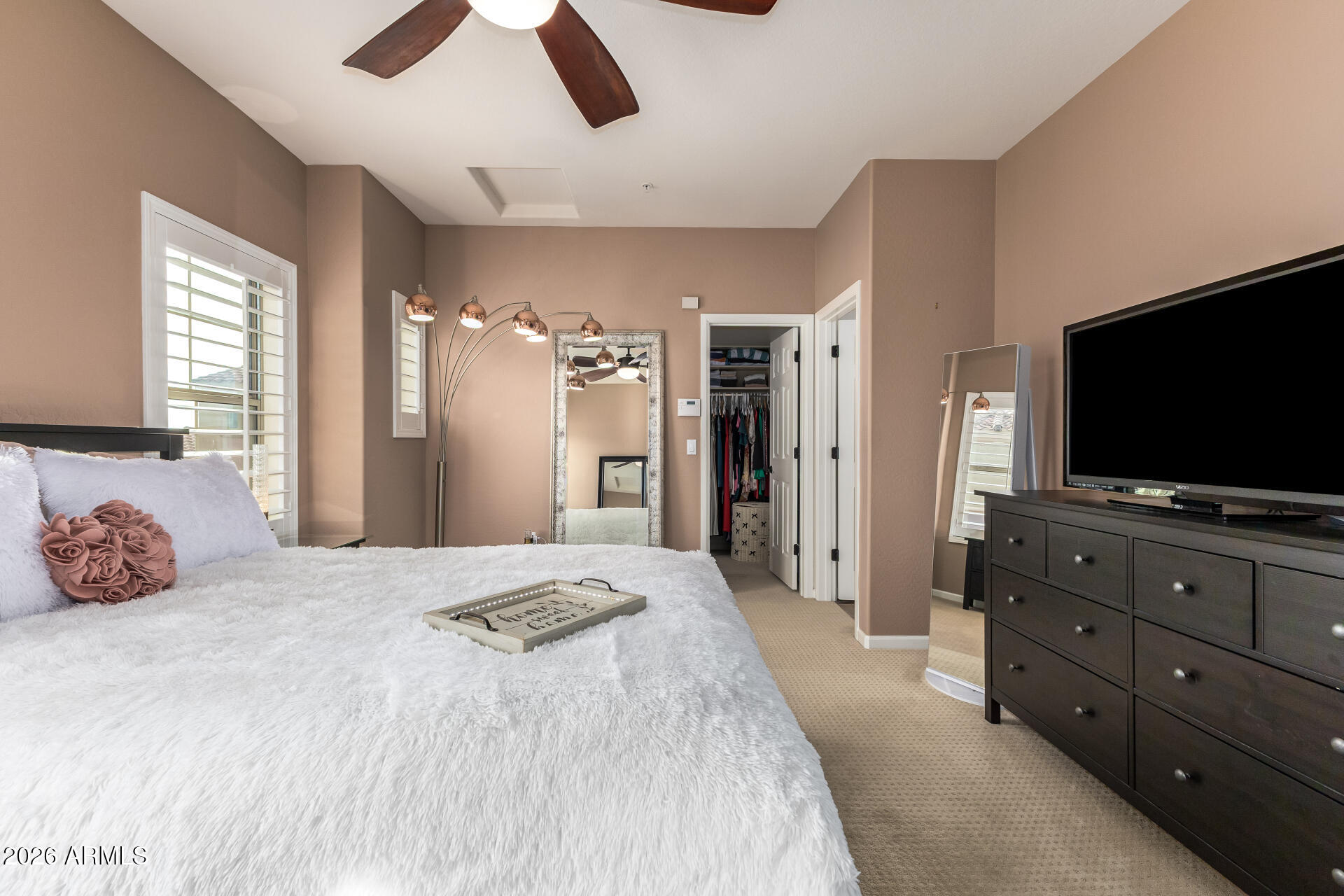 3935 East Rough Rider Road, Unit 1197 Phoenix, AZ 85050 - Photo 27 of 51 a bedroom with a bed and a flat screen tv