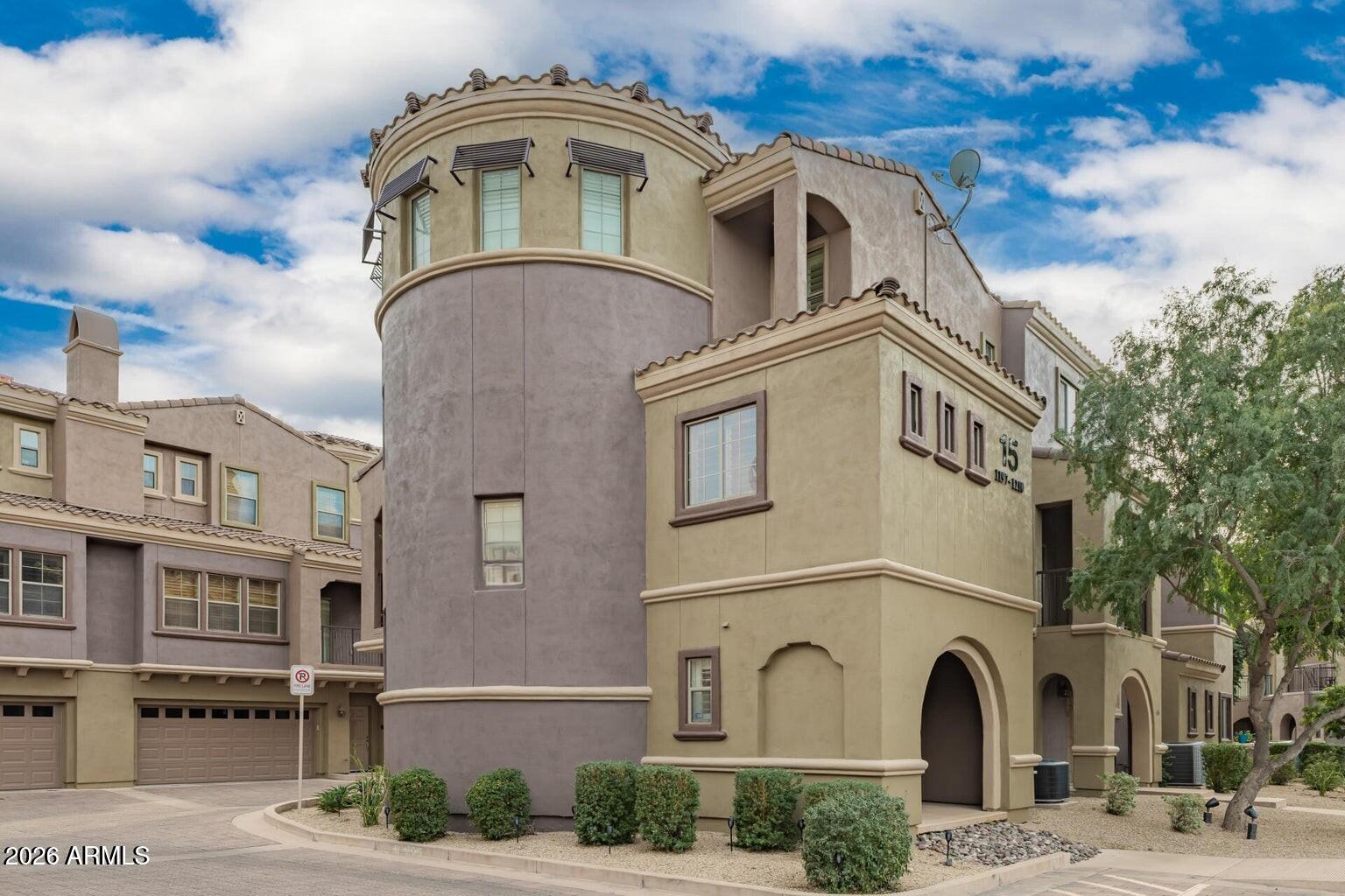 3935 East Rough Rider Road, Unit 1197 Phoenix, AZ 85050 - Photo 2 of 51 a front view of a residential houses