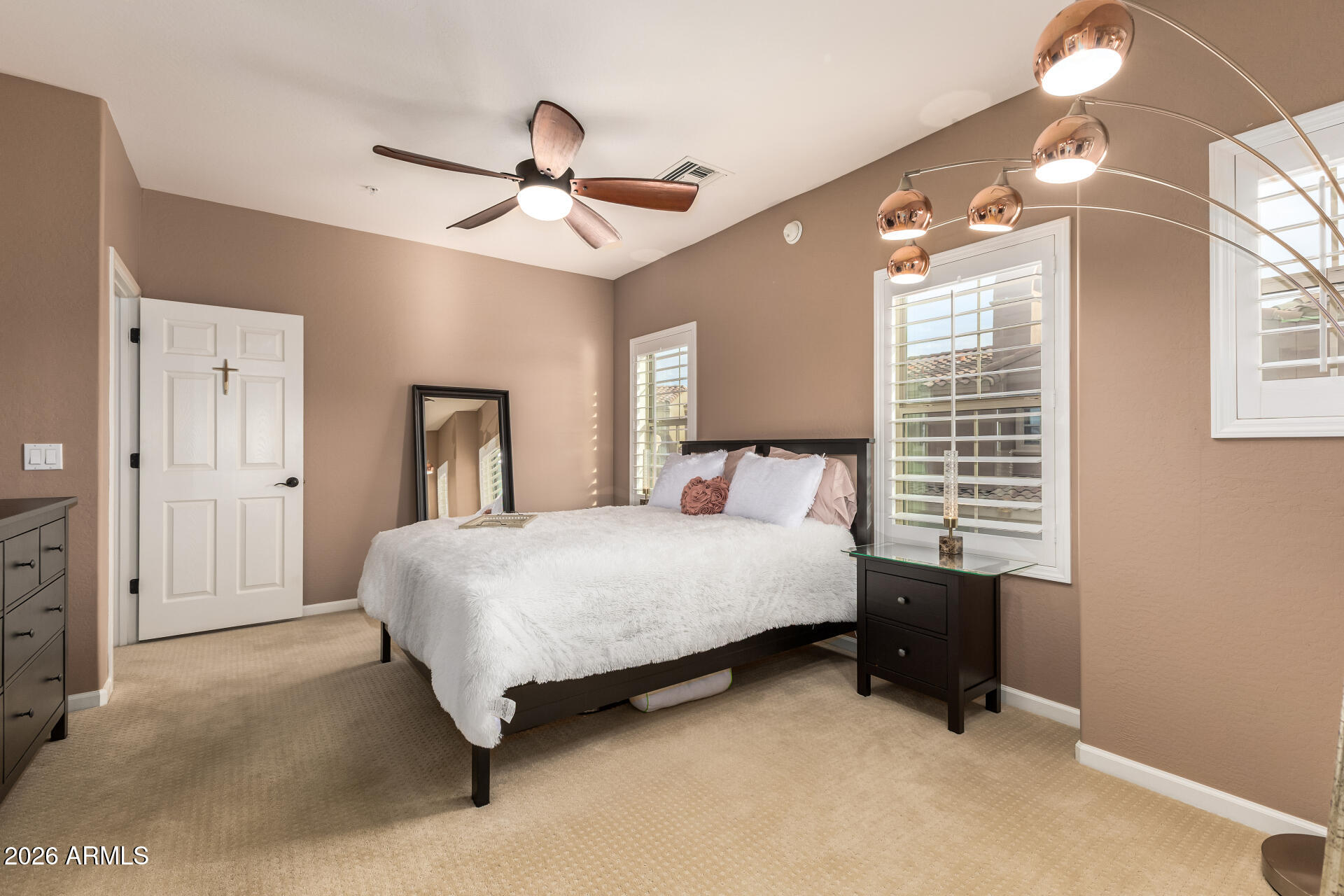 3935 East Rough Rider Road, Unit 1197 Phoenix, AZ 85050 - Photo 28 of 51 a bedroom with a bed wall painting and a window