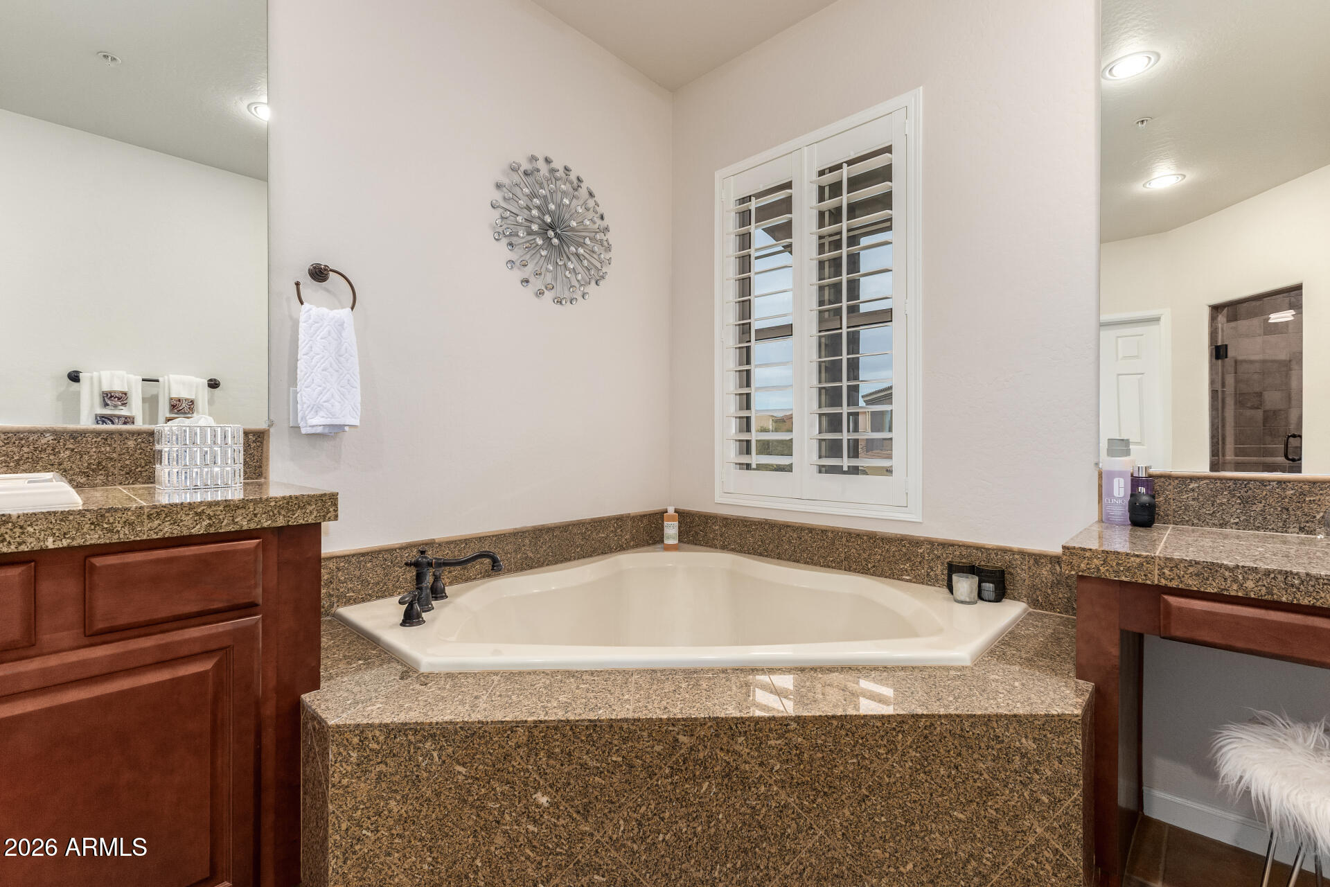 3935 East Rough Rider Road, Unit 1197 Phoenix, AZ 85050 - Photo 32 of 51 a bathroom with a granite countertop sink and a bathtub