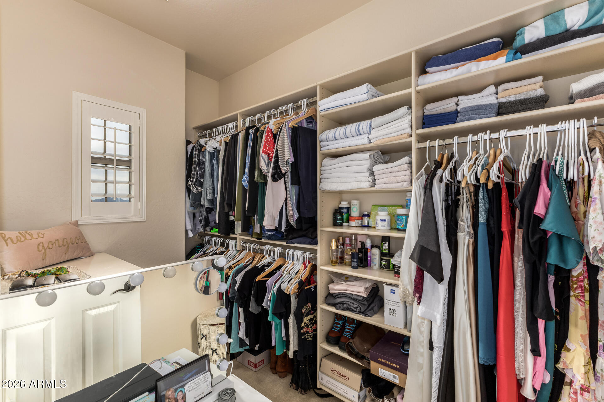 3935 East Rough Rider Road, Unit 1197 Phoenix, AZ 85050 - Photo 33 of 51 a view of walk in closet with clothes and shoes