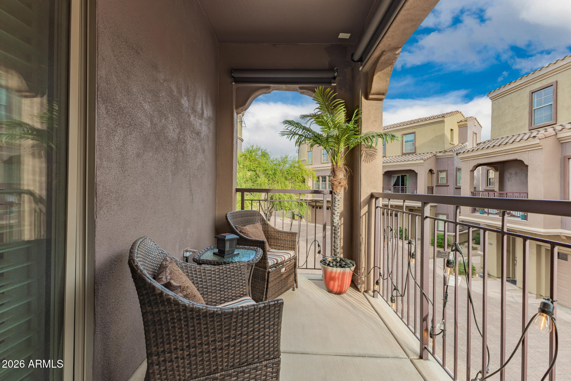 3935 East Rough Rider Road, Unit 1197 Phoenix, AZ 85050 - Photo 36 of 51 a balcony with furniture and potted plants