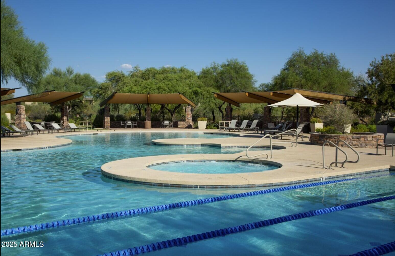 3935 East Rough Rider Road, Unit 1197 Phoenix, AZ 85050 - Photo 43 of 51 a swimming pool with outdoor seating and yard