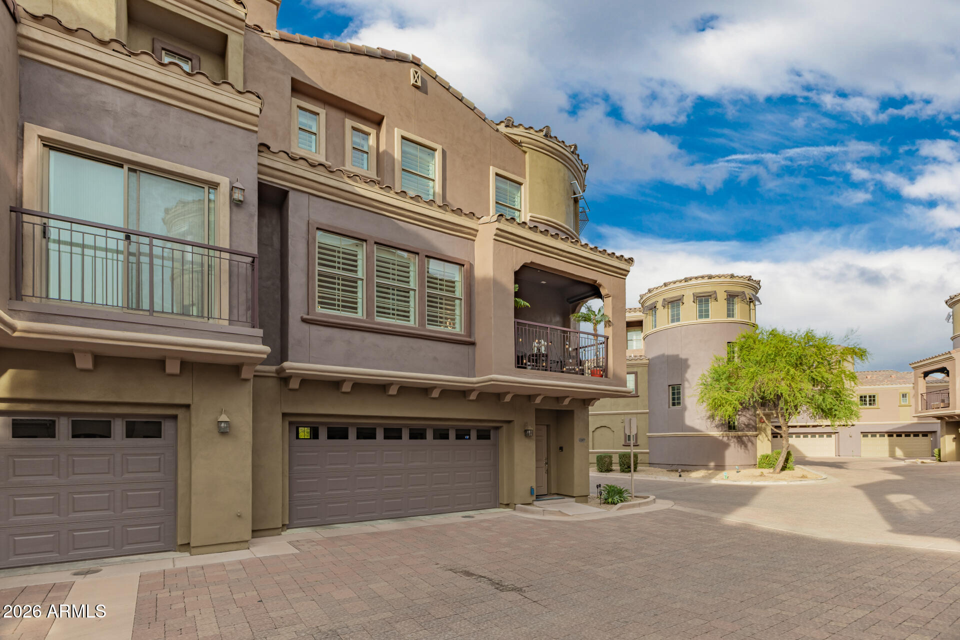 3935 East Rough Rider Road, Unit 1197 Phoenix, AZ 85050 - Photo 5 of 51 a large building with a lot of windows